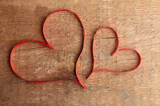 Cinta en forma de corazón sobre fondo de madera