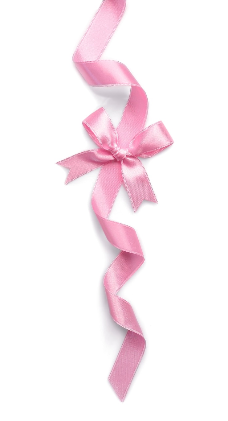 Foto cinta rosa con lazo sobre fondo blanco.