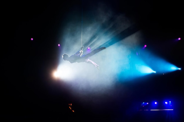 Foto circo. gimnastas de aire sobre lienzos. paños. artistas de circo. vuelo bajo la cúpula del circo