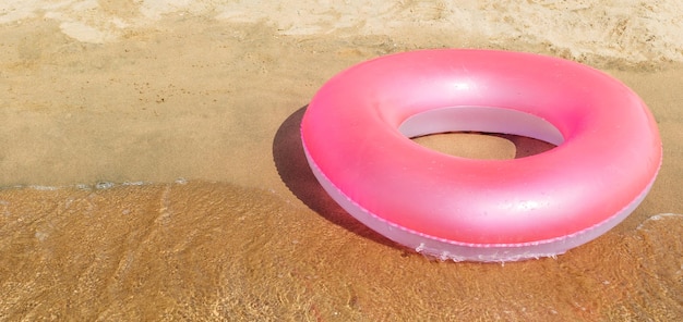 Círculo rosa flotando en la orilla del mar