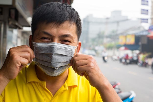 Cirsis de fuego de aceite de palma de Indonesia Los asiáticos usan mascarilla para proteger el sistema respiratorio causado por el incendio forestal y la quema de una plantación en Indonesia