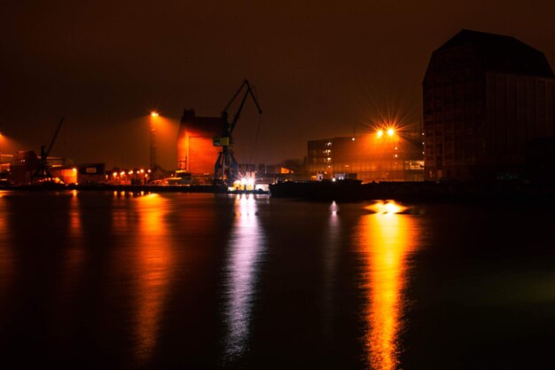 Foto ciudad iluminada por el mar contra el cielo nocturno