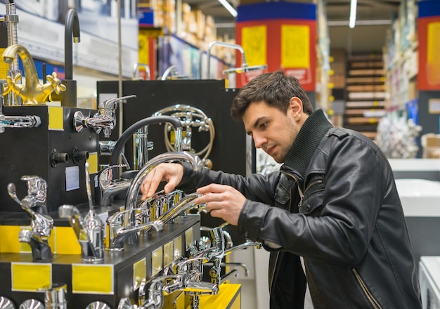 Cliente masculino escolhendo torneira ou torneira. conjunto de combinação para abastecimento de água