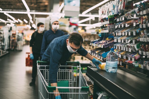 El cliente pone sus compras en el mostrador del supermercado.