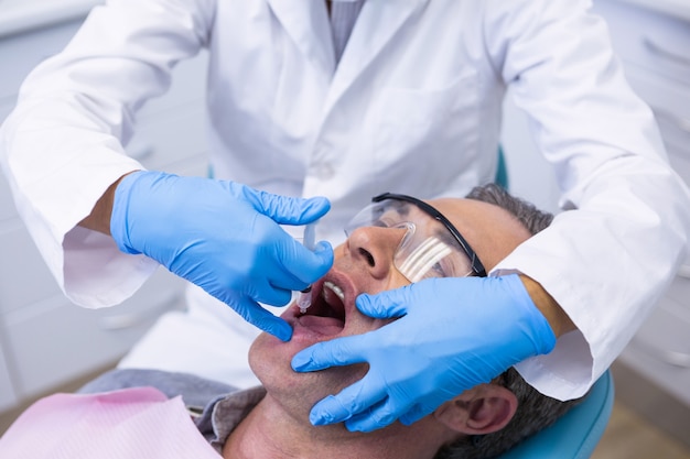 Close de médico dando tratamento dentário