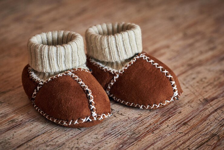 Foto close-up de botas de bebê na mesa