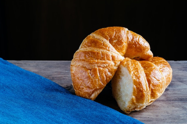 Close-up de croissant por tecido azul na mesa