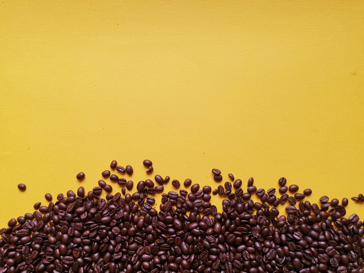 Foto close-up de grãos de café contra fundo amarelo