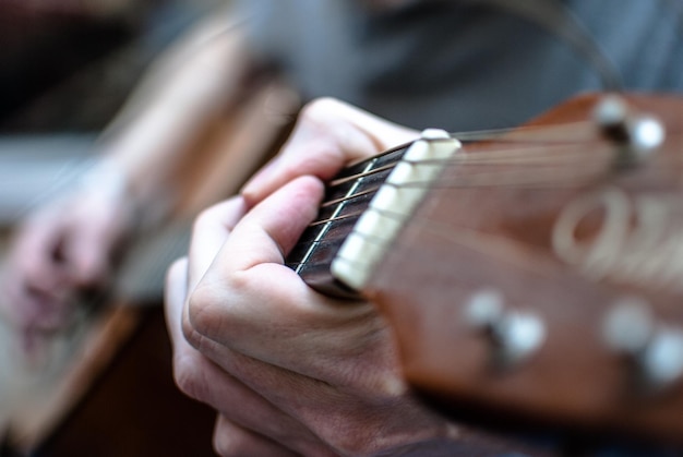 Close-up de mãos masculinas tocando guitarra