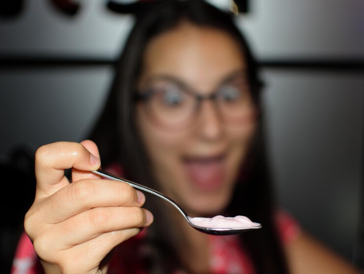 Foto close-up de mulher segurando colher com comida