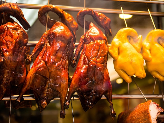 Foto close-up de patos assados pendurados no mercado