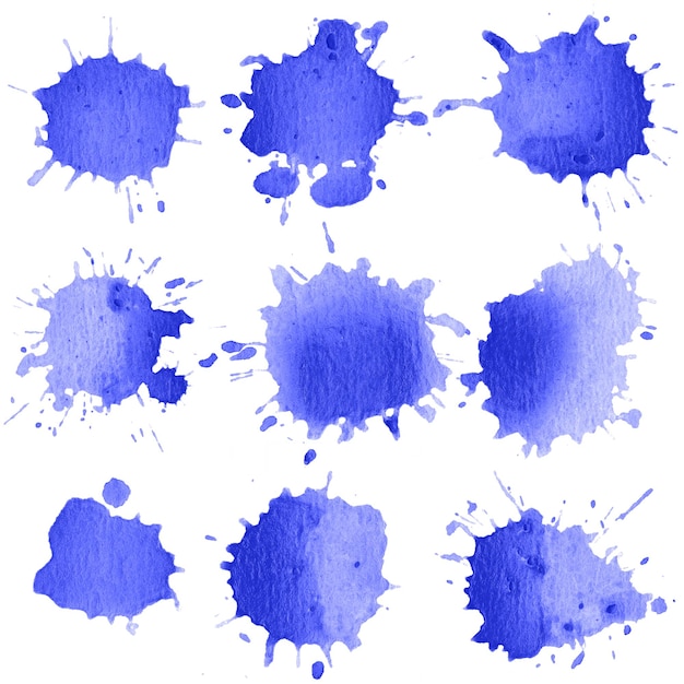 Foto close-up de salpico de cor azul em papel branco