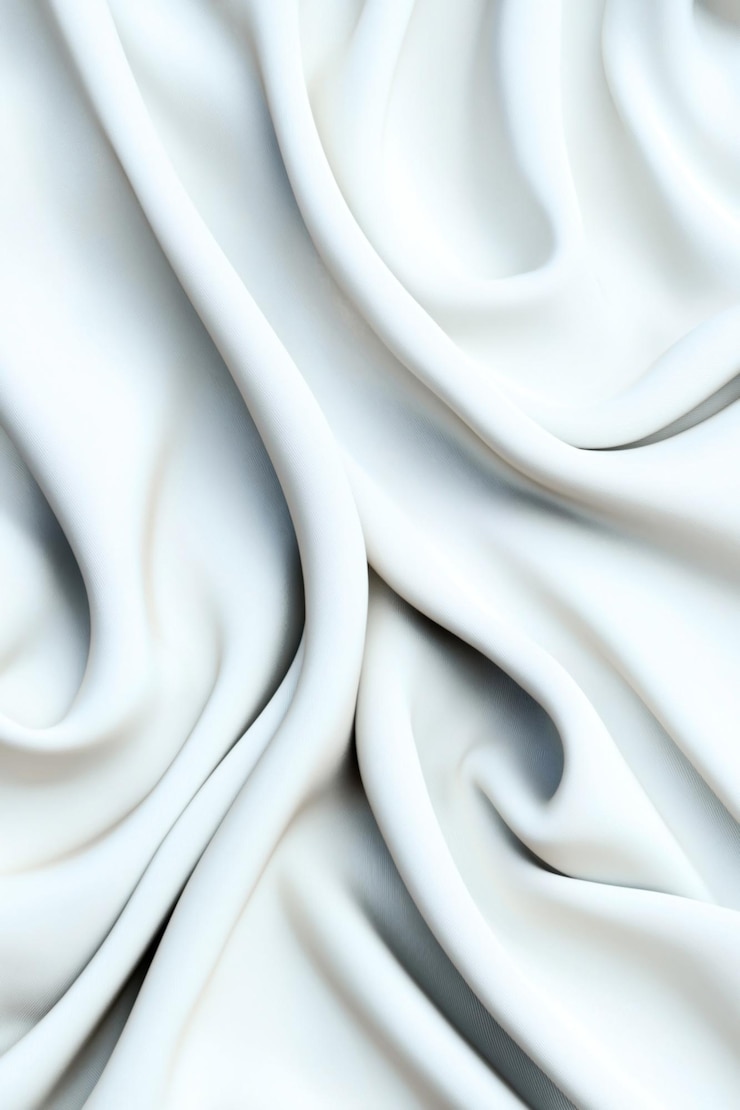 Foto close-up de tecido branco macio com drapes elegantes e dobras mostrando a textura suave e o fluxo delicado do material