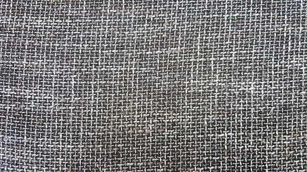 Close-up de textura de tecido cinza, plano de fundo e papel de parede. A textura do tecido é cinza, estofamento têxtil. Textura de tweed cinza, padrão de lã cinza.