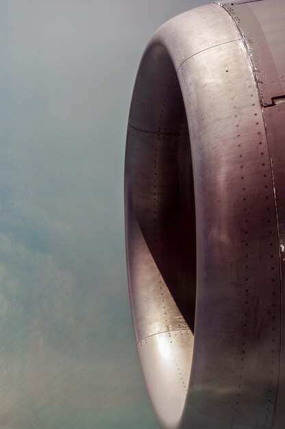 Foto close-up de um motor a jato de avião contra o céu