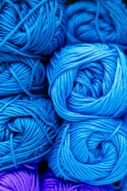 Close-up de uma escala de fios de lã azul claro, classificados por cor e armazenamento em uma prateleira