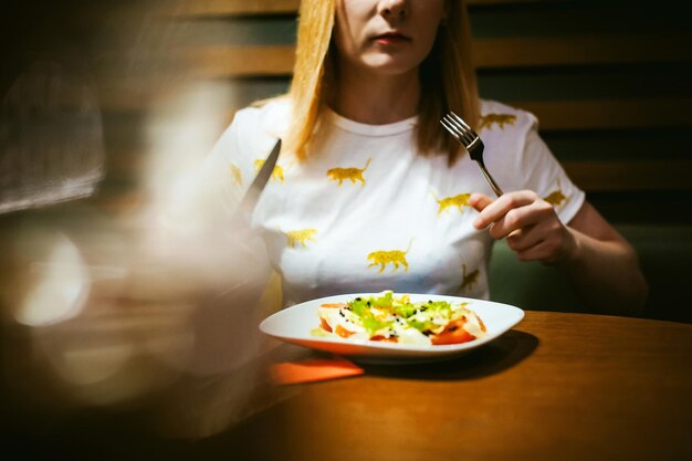 Foto close-up de uma mulher comendo em um restaurante