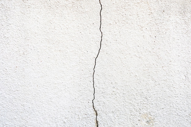Close up de uma textura de parede de concreto rachada e desgastada