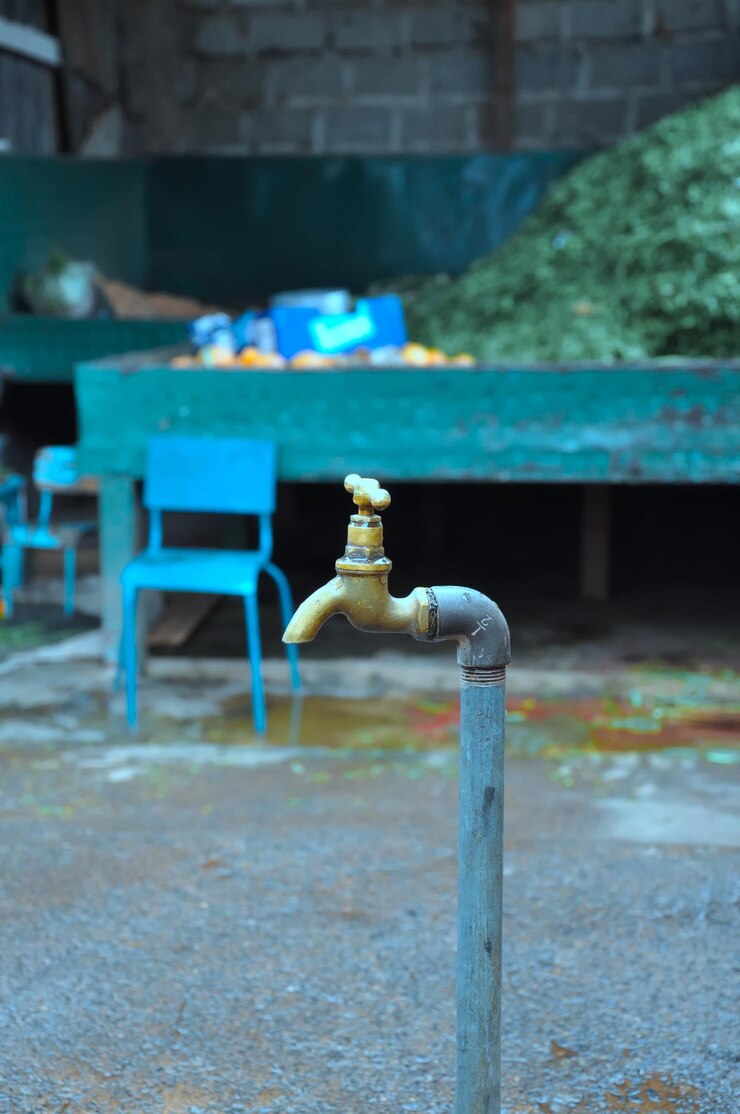 Foto close-up de uma torneira de água contra a parede azul