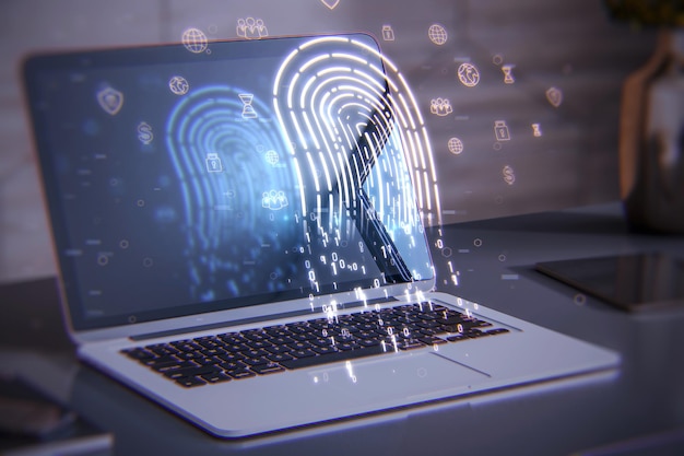 Close-up do laptop na área de trabalho com suprimentos e holograma de impressão digital brilhante Conceito de segurança e autenticação de identificação digital Dupla exposição