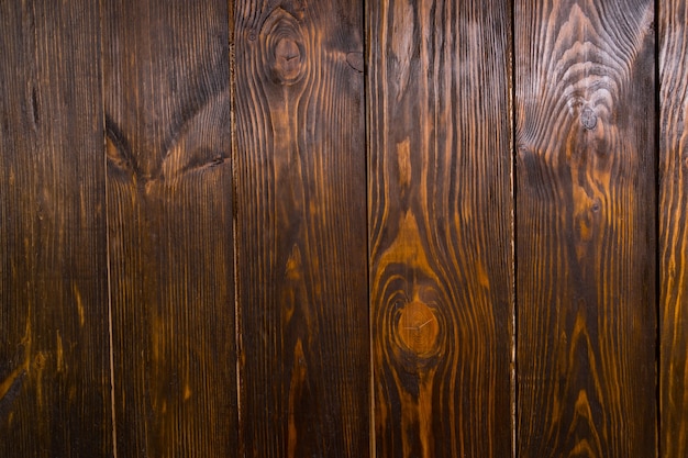 Close-up full frame de placas de madeira marrom escuro com grãos e nós visíveis