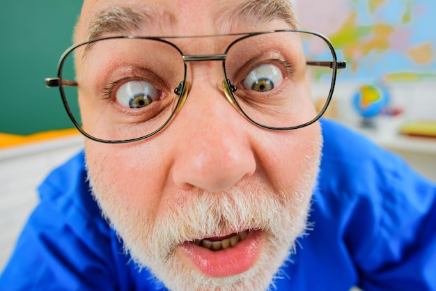 Foto close-up gesicht lustige lehrer in brille männliche lehrer oder professor in der schule klassenzimmer lernen und