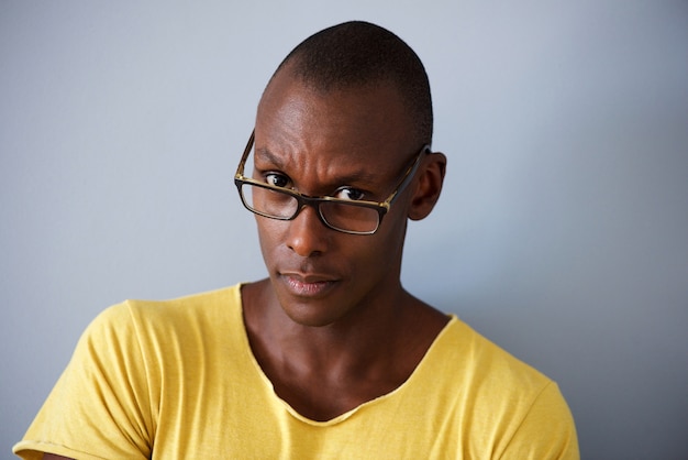 Close-up homem Africano com óculos contra fundo cinza