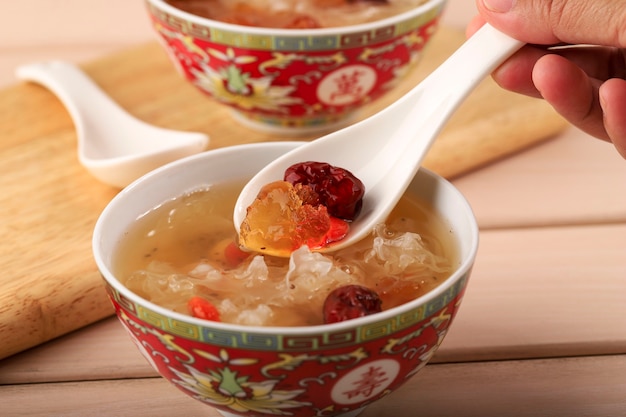 Close Up Löffel mit Peach Gum Collagen Dessert ist ein chinesisches traditionelles Erfrischungsgetränk. Es enthält Vogelnest, rote Datteln, Schneepilz, Goji-Beere.