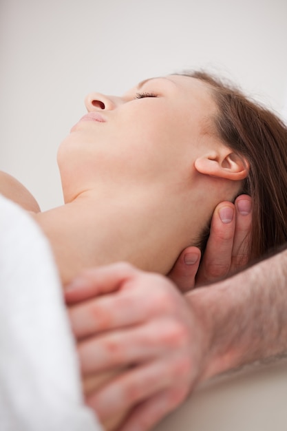 Foto close-up of neck of woman beig manipulando por um terapeuta