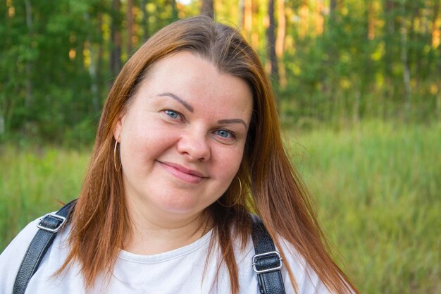 Close-up-Porträt einer glücklichen Frau im Park an einem warmen, sonnigen Tag