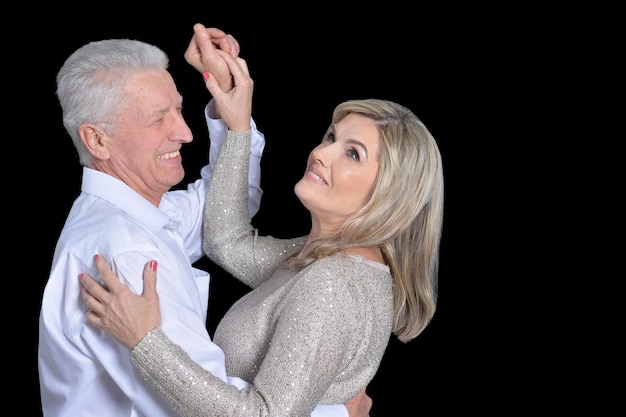 Close Up retrato de feliz pareja senior bailando sobre fondo negro