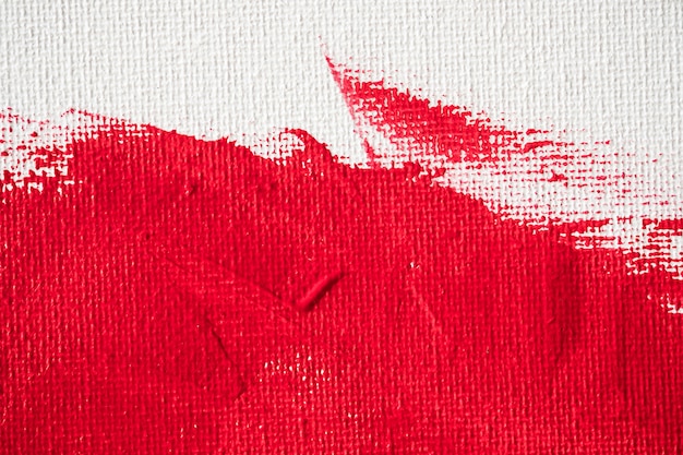 Close up textura color rojo pintura sobre lienzo blanco