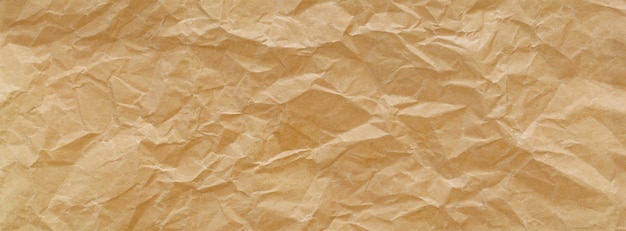 Close-up tiro de luz marrom amassado papel reciclado textura banner fundo