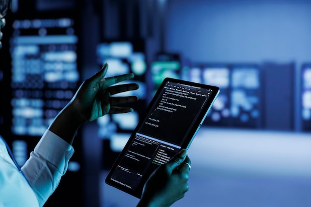 Close-up von Mitarbeitern, die Code und Programmierung auf Laptops ausführen, Fehlerbehebung und Aktualisierung von Hightech-Einrichtungen, die für mehrere Cluster voll funktionsfähiger Server-Hardware konzipiert sind