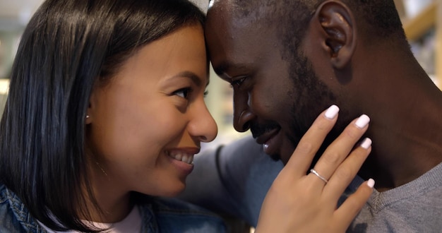 Closeup amando casal mestiço abraçando e sorrindo