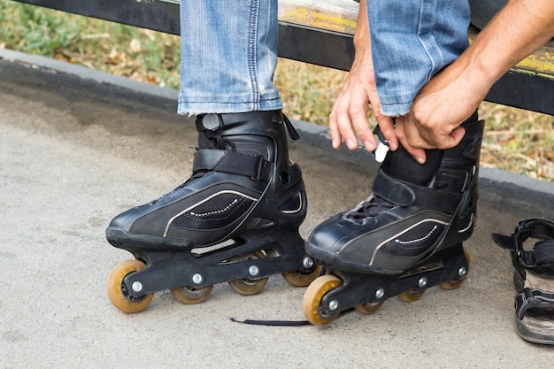 Closeup de cara homem colocando patins ao ar livre