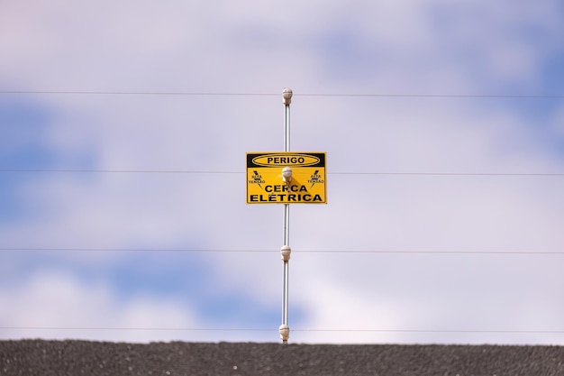 closeup de cerca elétrica com sinal de perigo de cerca elétrica