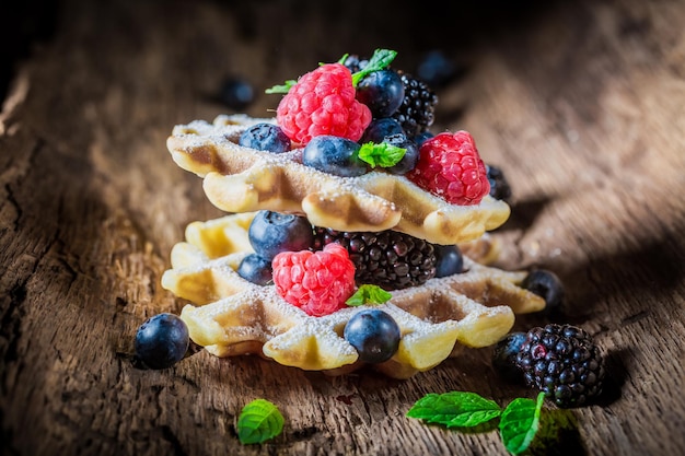 Closeup de frutas frescas com waffles na casca de madeira