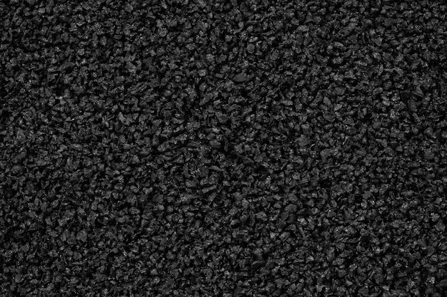 Foto closeup de fundo de grânulos de polímero de plástico preto