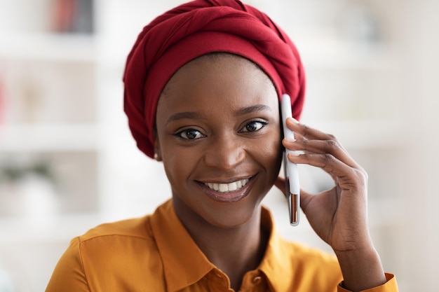 Closeup retrato de mujer bastante negra hablando por teléfono