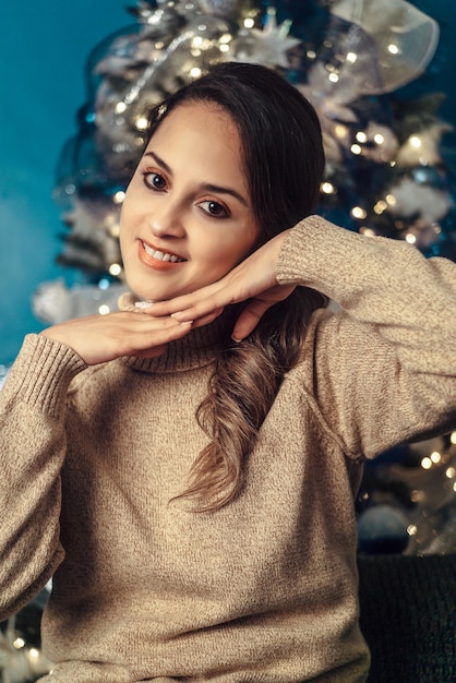 Foto closeup retrato de mujer joven muy hermosa sobre fondo de navidad