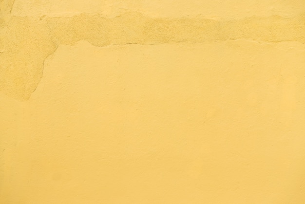 Closeup textura de cemento de pared amarilla.