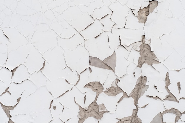 Closeup textura de parede de concreto branco com gesso rachado