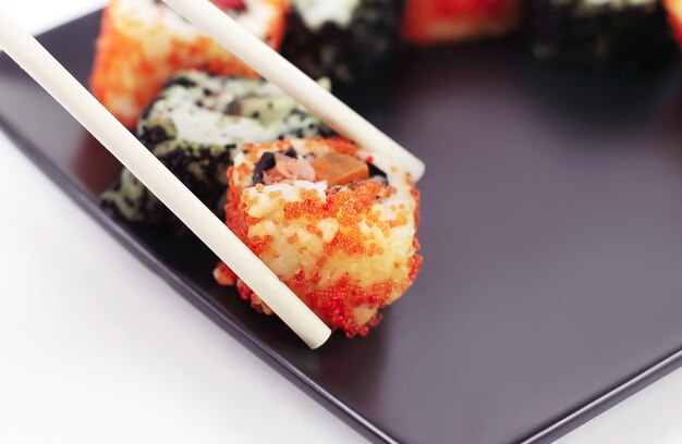 Foto closeupsticks e um conjunto de rolos de sushi