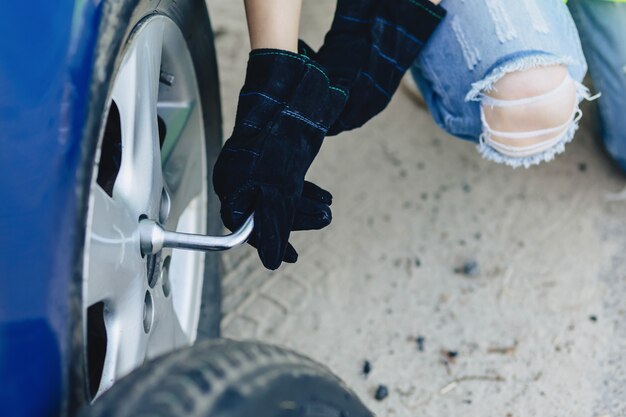 Foto closup mãos desmontar a roda do carro