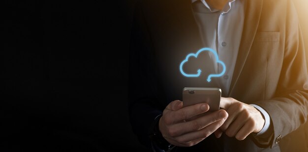 Cloud-Computing-Konzept - Smartphone mit Cloud verbinden. Geschäftsmann oder Informationstechnologe mit Cloud-Computing-Symbol und Smartphone. Geschäfts-, Technologie-, Internet- und Netzwerkkonzept.