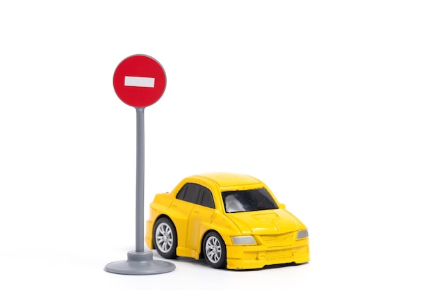 Coche amarillo con señal de parada aislada sobre un fondo blanco