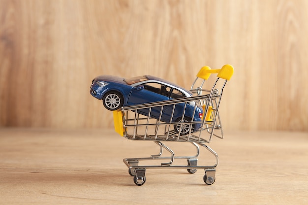 Coche en una canasta sobre un fondo de madera