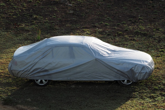 Coche cubierto con una cubierta protectora.