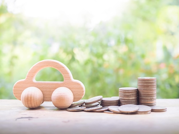 Coche de juguete de madera y pila de monedas El concepto de ahorro para coche